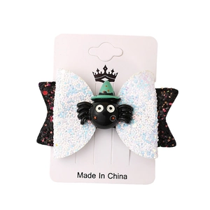 Halloween bow hair clip with black spider and wizard hat on white card display