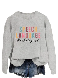Flat lay of gray speech language pathologist sweatshirt with denim shorts on white background