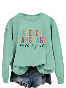 Detail of mint green sweatshirt with Speech Language Pathologist colorful typography print
