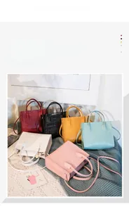 Group of colorful faux crocodile pattern handbags on a soft knit blanket background