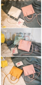 Close-up of crocodile pattern texture on colorful stylish top-handle crossbody bags
