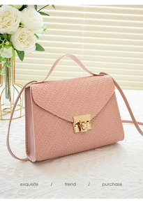 Pink woven leather detail on flap bag featuring a square gold lock and top handle