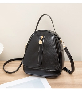 Detailed view of the black PU leather texture and golden zipper on this mini crossbody bag
