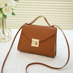 Elegant brown woven texture square bag with gold lock and chain on a stylish background