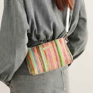 Colorful woven crossbody beach bag with rainbow stripes and white leather shoulder strap