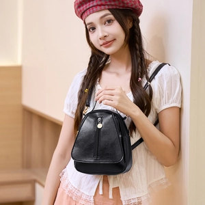 Women black leather mini crossbody phone bag with gold zipper and geometric design