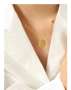Detail of 18K gold-plated bead chain with square pendant engraved with Good Luck and smileys