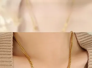 Close-up of golden heart pendant necklace layered with beaded chain on a model