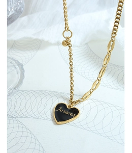 Detail showing the golden heart pendant with Forever engraving on a beaded chain