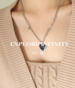 Detail view of a silver-toned heart pendant necklace with Forever engraving and bead