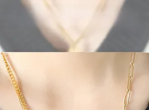 Close-up of double layer gold layered necklace with paperclip chain on female neck