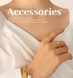 Detail of gold geometric bracelet with freshwater pearl and engraved handmade charm
