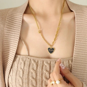 Layered gold heart pendant necklace with Forever engraving and black enamel inlay
