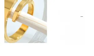 Detail of twisted 18K gold plated minimalist ring with high-polished mirror finish surface