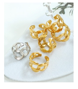 Close-up of gold and silver chunky link chain rings with high-polish metallic finish