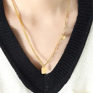 Asymmetrical gold double chain necklace with heart and square engraved pendants