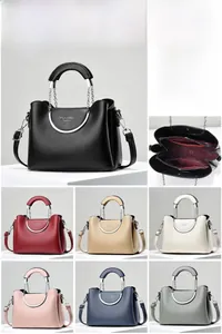 Detailed view of structured leather handbag showing internal zipper pockets and dimensions