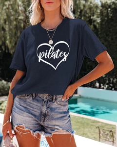 Close-up of navy blue Pilates heart print T-shirt styled with denim shorts outdoors