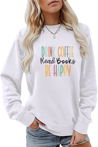Detail of white crewneck sweatshirt featuring colorful Drink Coffee slogan art print