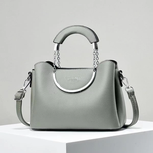 Chic grey lychee texture handbag with silver metal circular handles and crossbody strap