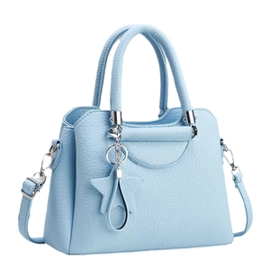 Light blue litchi pattern handbag with top handles and adjustable strap in 45-degree view