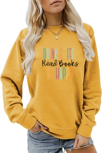 Detail of DRINK COFFEE typography print on yellow long sleeve crewneck sweatshirt