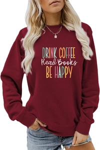 Detail of burgundy sweatshirt featuring Drink Coffee Read Books Be Happy colorful print
