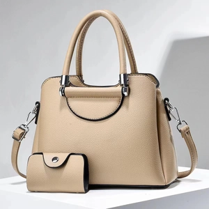 Detail of beige litchi leather handbag set with matching coin purse and detachable strap