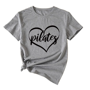 Detail of grey Pilates heart graphic T-shirt featuring a stylish side-tied knot design