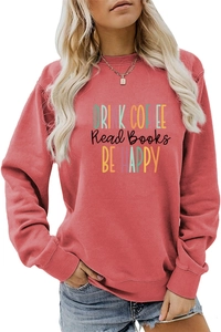 Close-up of artistic Drink Coffee Read Books Be Happy print on coral pink sweatshirt