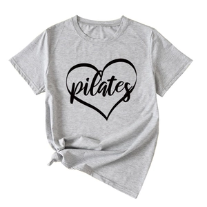 Detail of grey Pilates heart print T-shirt showing modern knotted hem design