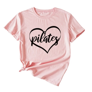 Close-up of pink Pilates T-shirt with black heart print and stylish front knot detail