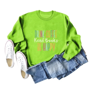 Flat lay of neon green sweatshirt with Drink Coffee slogan print and denim shorts