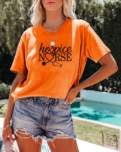 Détail du t-shirt orange pour infirmière avec motif de stéthoscope et short en jean