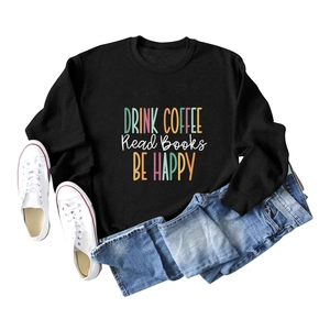 Detail of black crewneck sweatshirt featuring Drink Coffee Read Books Be Happy print