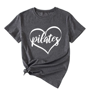 Detail of grey Pilates T-shirt showing white heart print and stylish knotted hem design