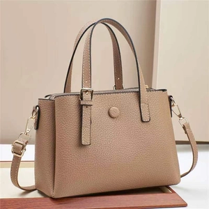 Elegant beige lychee textured leather tote bag with gold hardware and shoulder strap