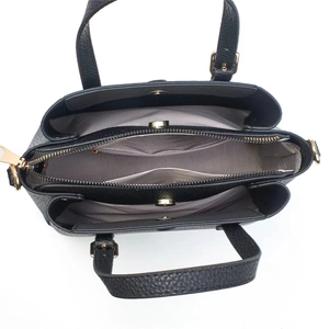 Top view of black pebbled leather handbag featuring three-layer interior and gold hardware