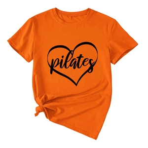 Detail of orange Pilates T-shirt with heart graphic and decorative side knot waistline