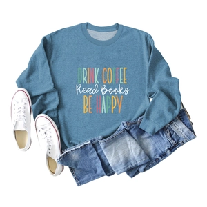 Flat lay of blue cotton sweatshirt with Drink Coffee text and denim shorts outfit