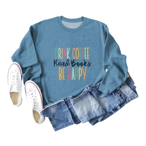 Flat lay of blue DRINK COFFEE sweatshirt with denim jeans and white canvas sneakers