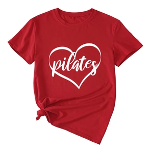 Detail view of red pilates t-shirt with heart print and stylish knotted hem design