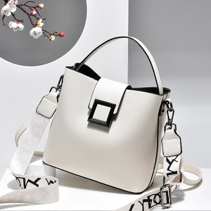 White lychee leather bucket handbag with broad printed strap and black matte square buckle