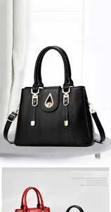 Detail of lychee pattern leather handbag featuring golden teardrop twist lock and stitching