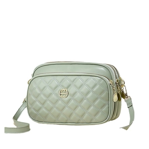 Minimalist light green quilted shoulder bag with three zippers and golden hardware