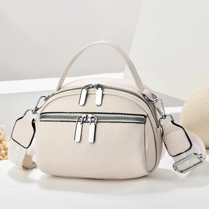 Detail of off-white lychee texture leather shell bag with jacquard strap and silver hardware