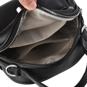 Detail of black pebbled leather handbag with herringbone lining and interior zipper pocket