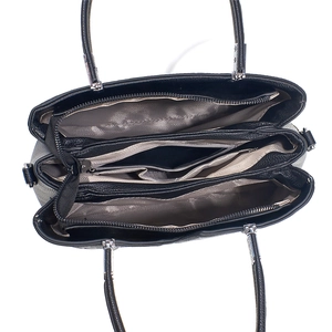 Top view of large capacity crossbody bag interior with three compartments and wave lining