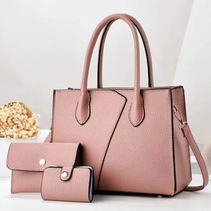 Detailed view of pink pebble grain leather tote bag set with matching wallet and card pouch