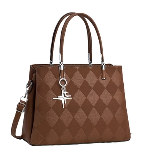 Brown quilted leather crossbody handbag for women with metallic pendant and top handles